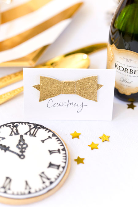If you are ringing in the New Year at home try this metallic tablescape New Years Eve Tablescape place card