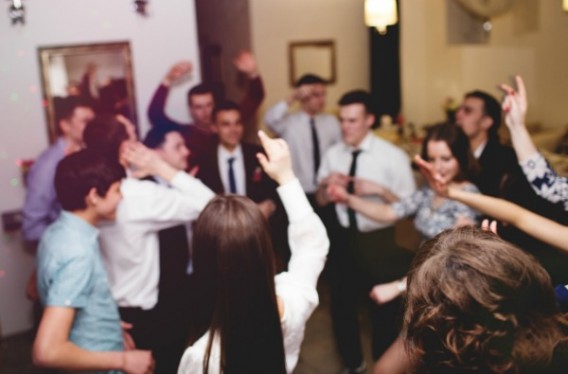 Group of young people having fun dancing at party