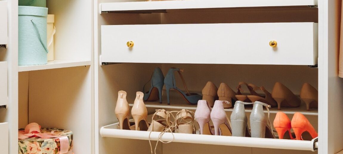 Shoes neatly displayed on closet shelf.
