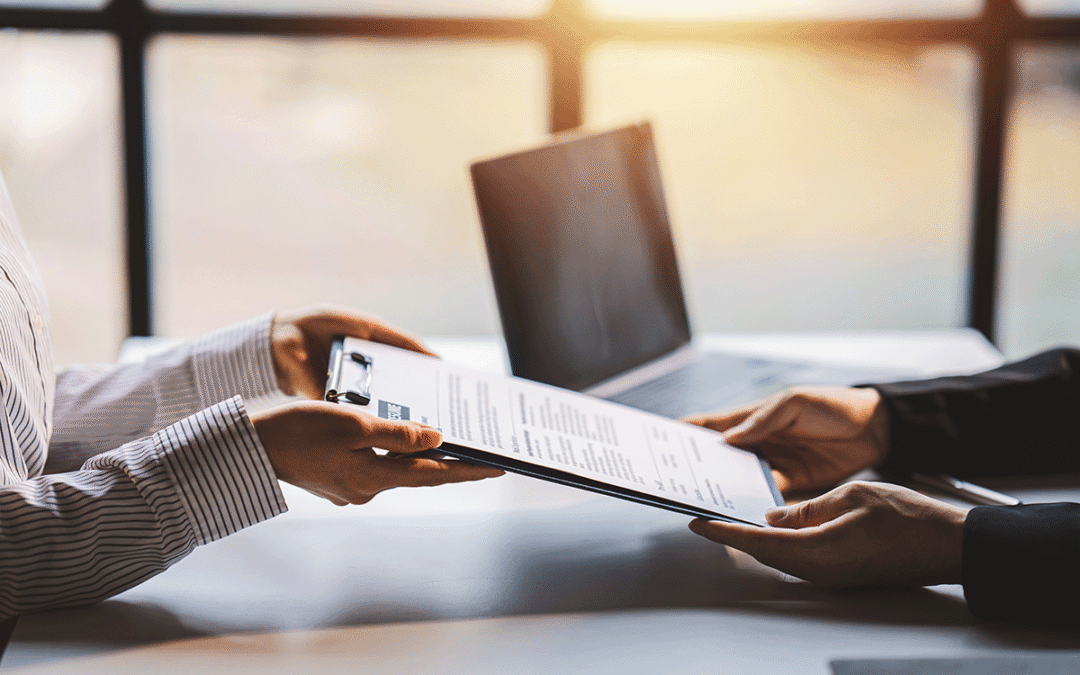 A renter hands a rental resume to a landlord.