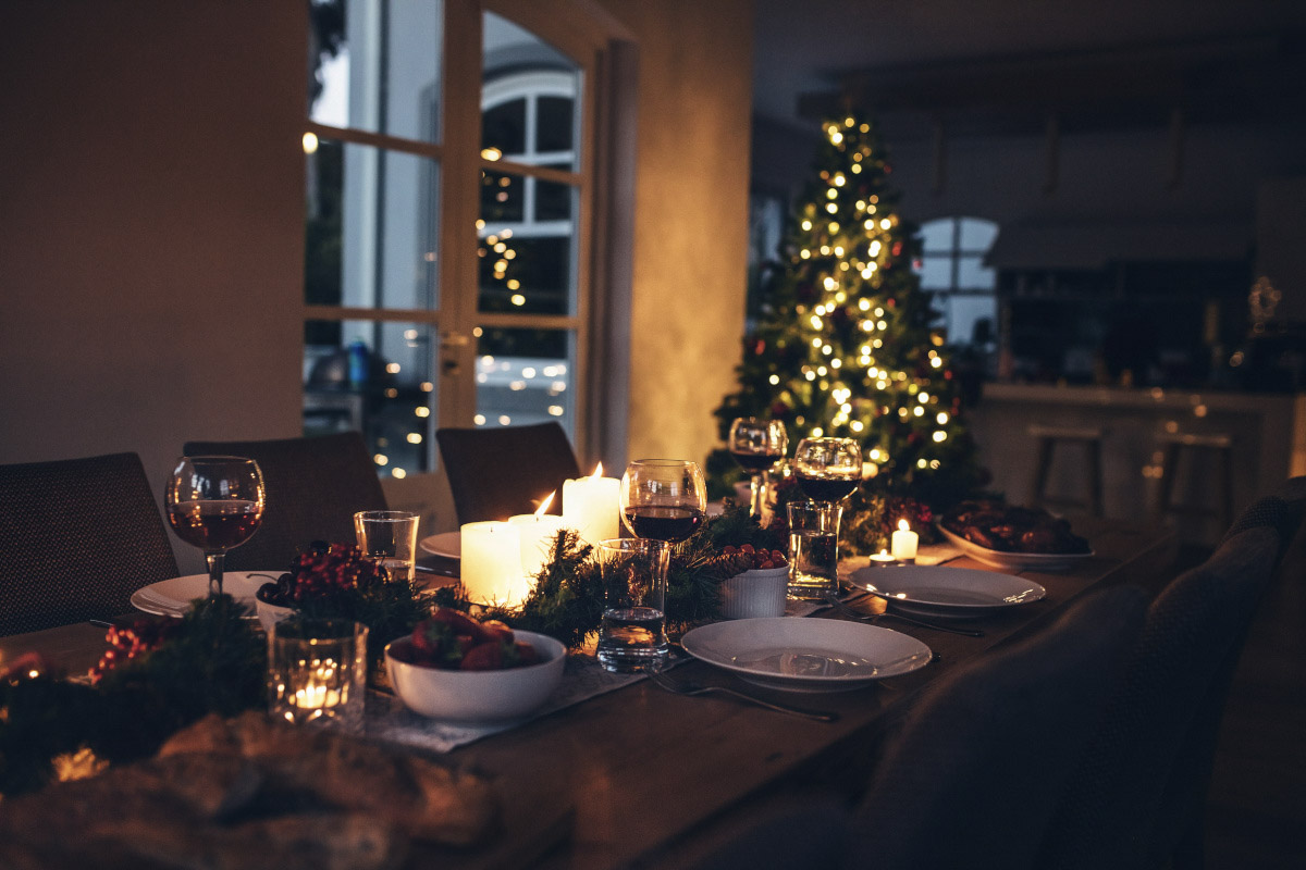 A shot of a dining table decorated for the holidays at candlelight.