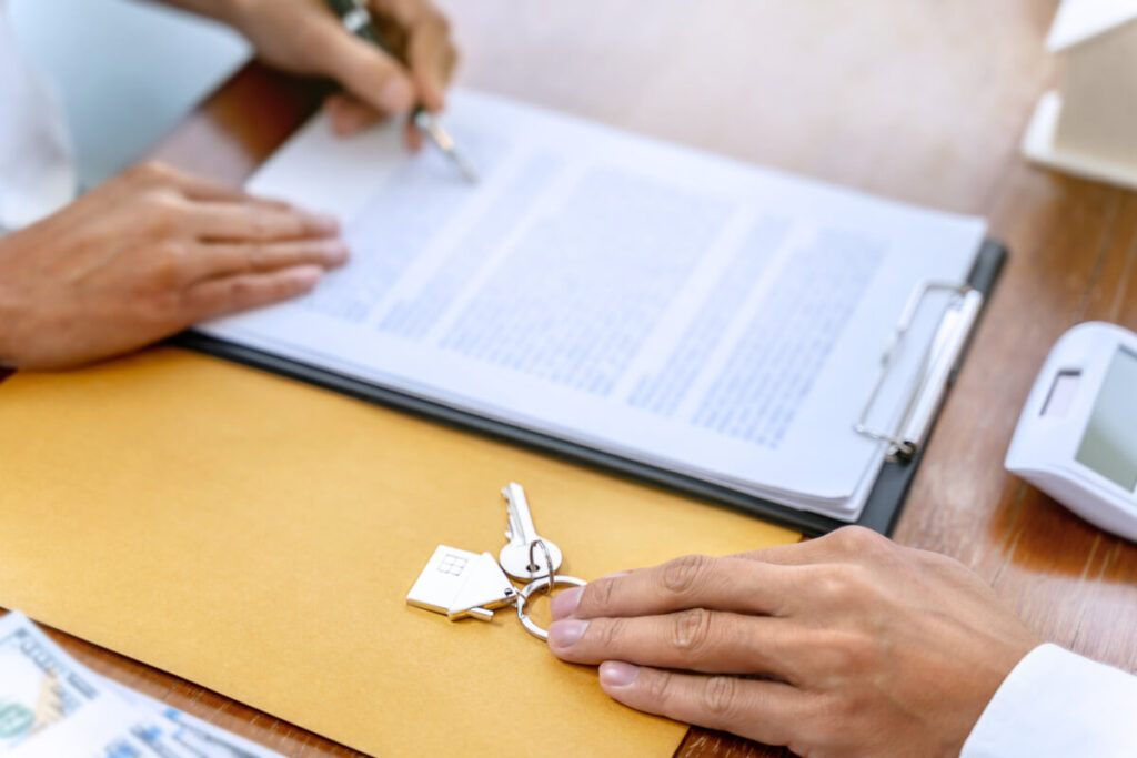 Landlord and tenant participate in lease signing process. 