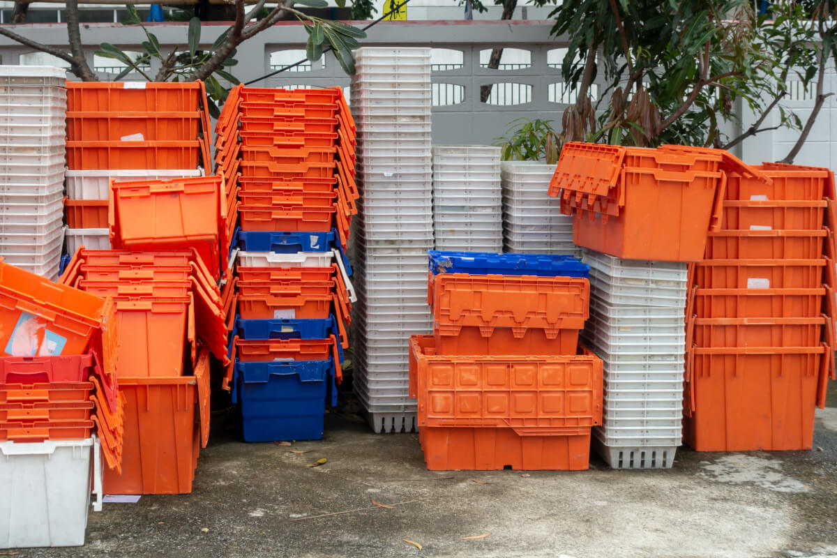 A bunch of plastic reusable bins stacked on top of each other to be used as moving boxes.