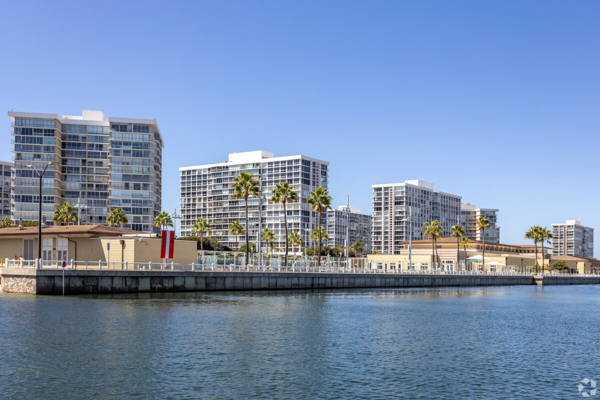 Waterfront high-rises in Coronado, San Diego, with palm trees and marina views—ideal for luxury apartment seekers and urban coastal living.