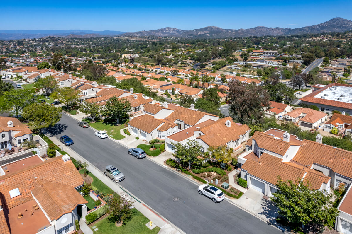 Rancho Bernardo neighborhood with red tile-roofed homes and mountain views, representing peaceful suburban living in northeast San Diego.