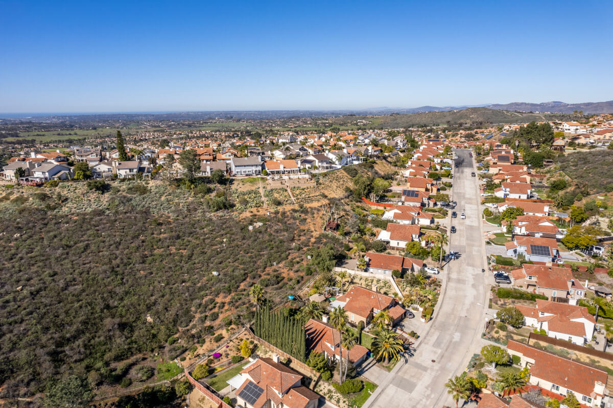 Elevated view of Rancho Peñasquitos, San Diego, displaying hillside homes and expansive greenery.