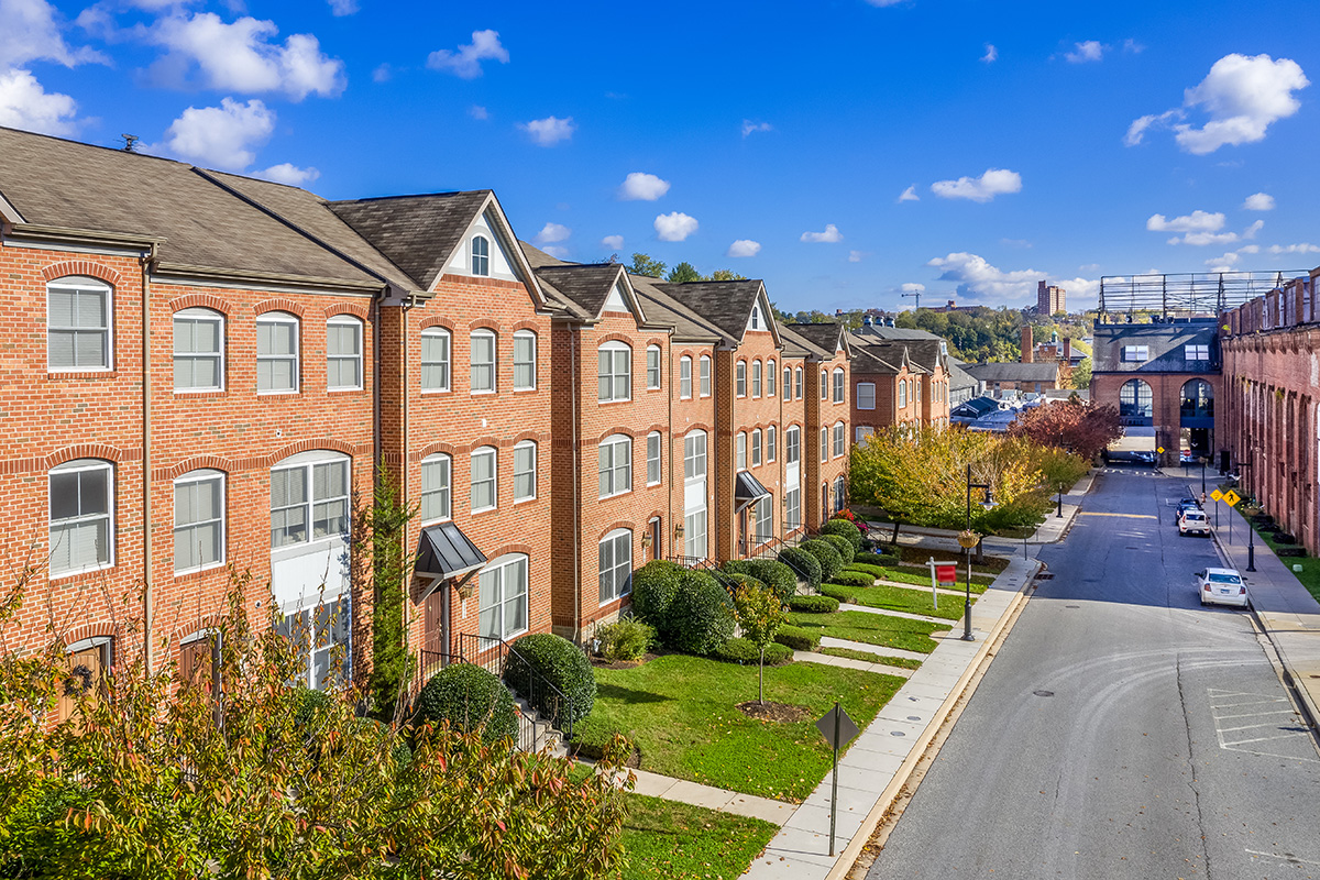 An aerial view of a neighborhood of brick townhomes.