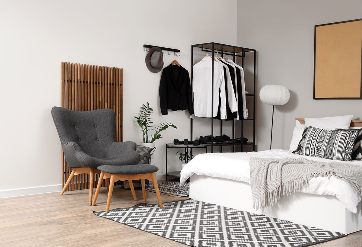 Clothing rack styled in an apartment bedroom.
